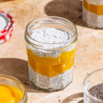 Chia pudding in jars layered with mango puree.