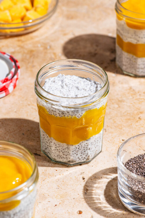 Chia pudding in jars layered with mango puree.