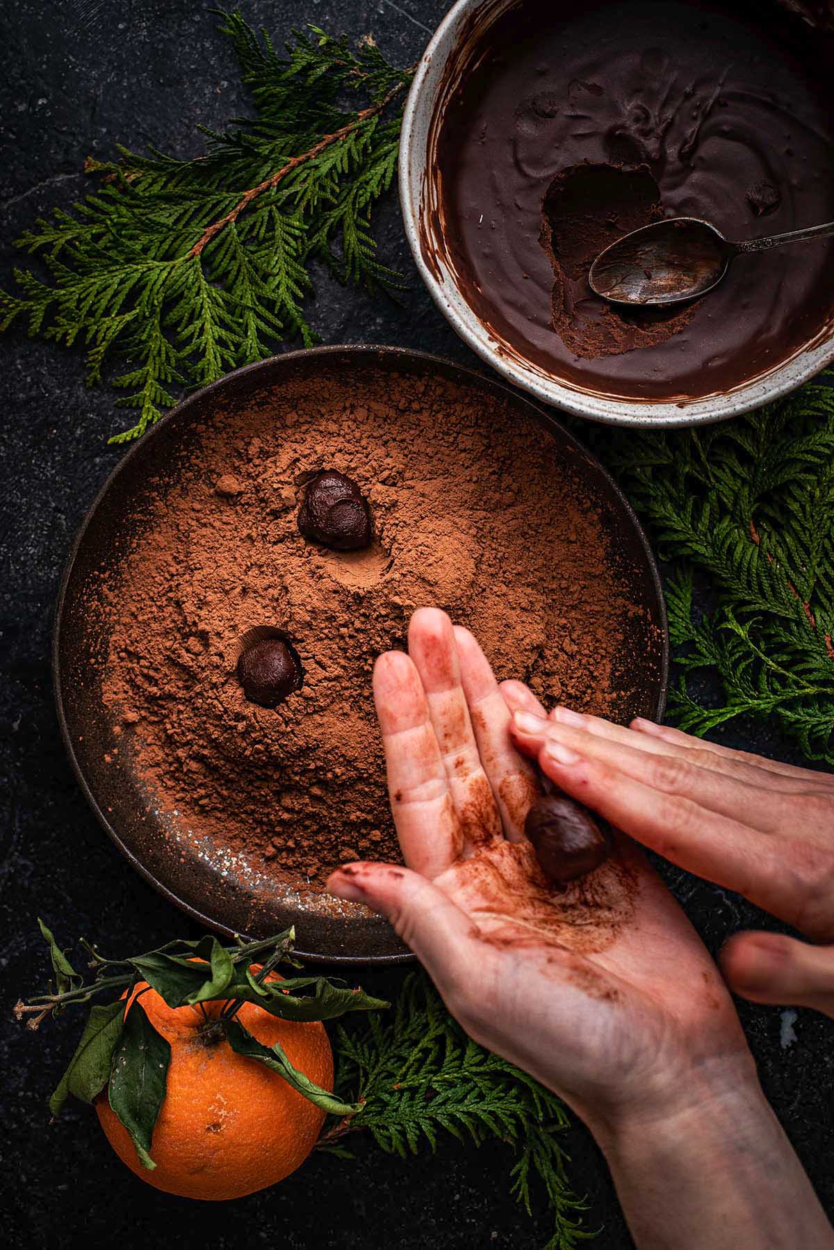 Rolling chocolate truffles into balls.