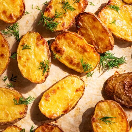 Golden baked small halved potatoes with fresh dill.