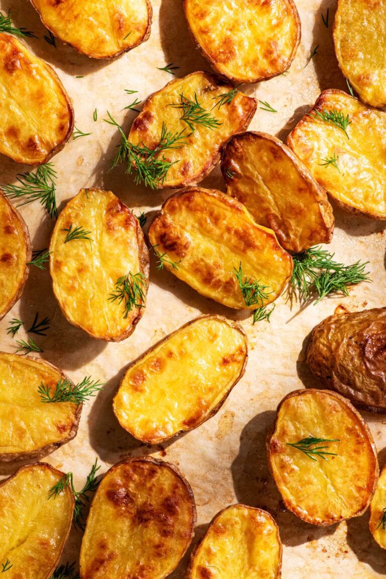 Golden baked small halved potatoes with fresh dill.