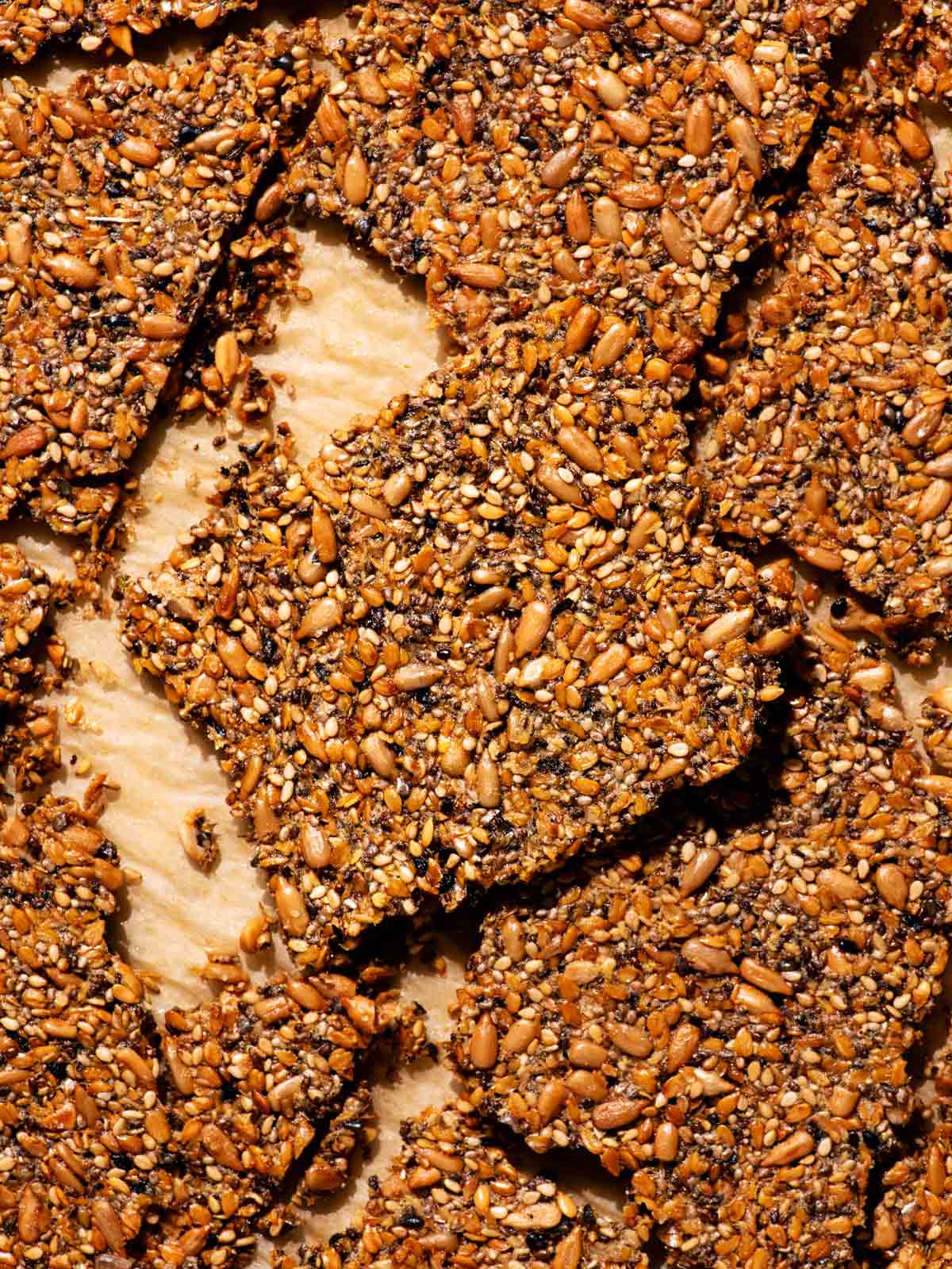 Several large crackers on a baking sheet.