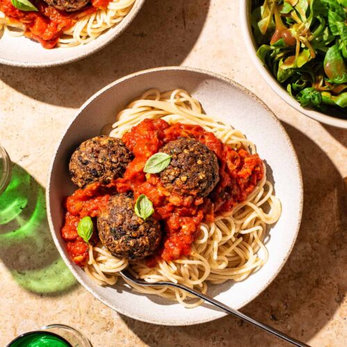 Bean balls with spaghetti and tomato sauce in two bowls.
