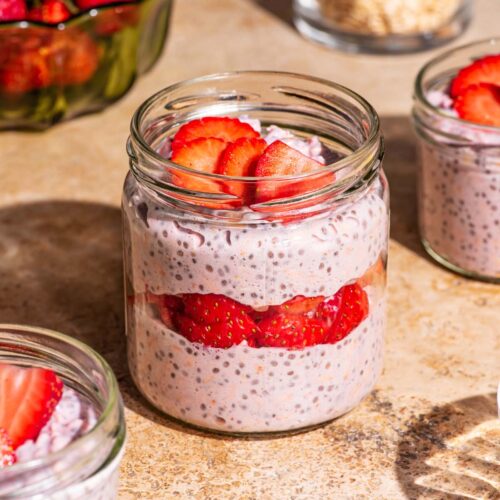 Overnight oats with strawberries layered in jars.