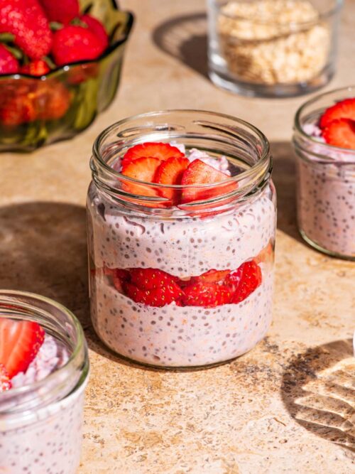 Overnight oats with strawberries layered in jars.