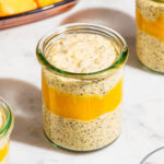 Mango chia seed pudding in small glass jars with mango puree layered in.