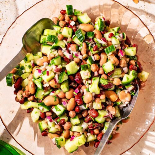 Bean and cucumber salad in a glass serving bowl.