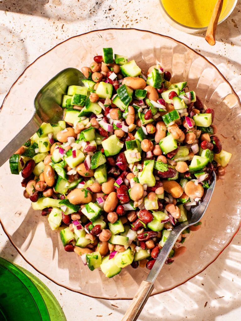 Bean and cucumber salad in a glass serving bowl.