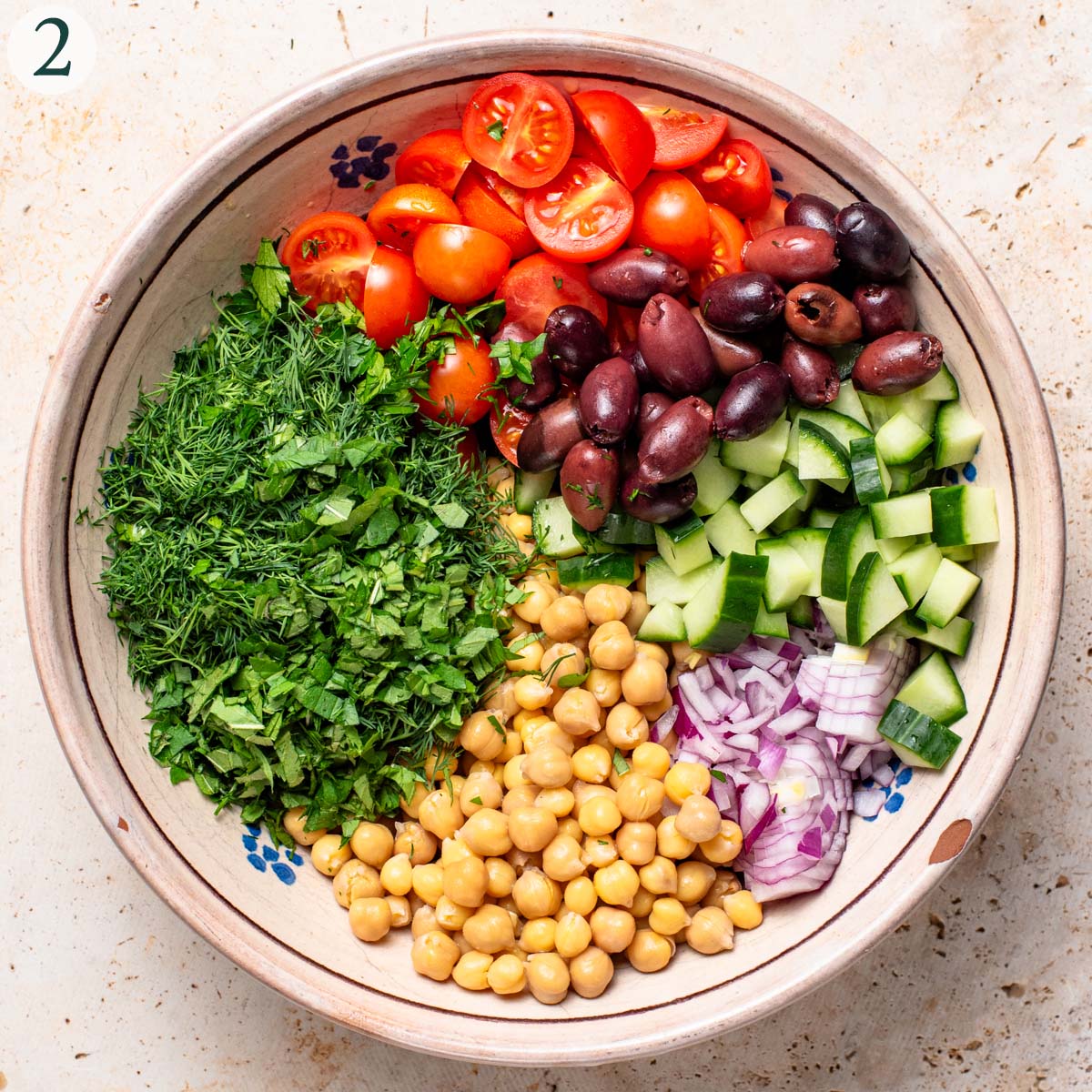 Salad step 2, salad ingredients arranged in a mixing bowl.