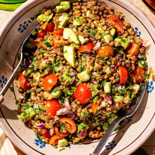 Serving bowl filled with lentil vegetable salad.