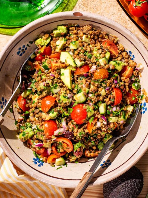 Serving bowl filled with lentil vegetable salad.
