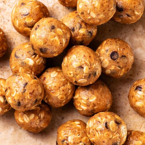 Several energy bites piled together on a stone background.