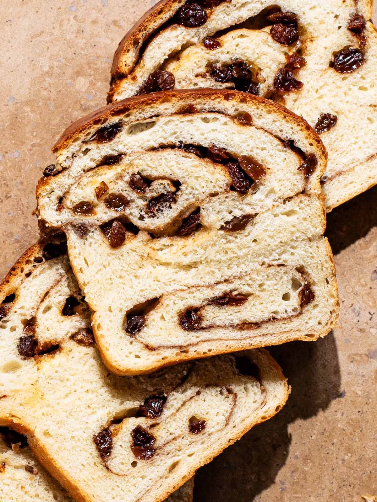 Close up of slices of raisin swirl bread.