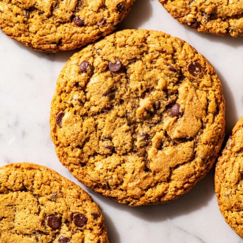 Chocolate chip cookies on a marble work surface.