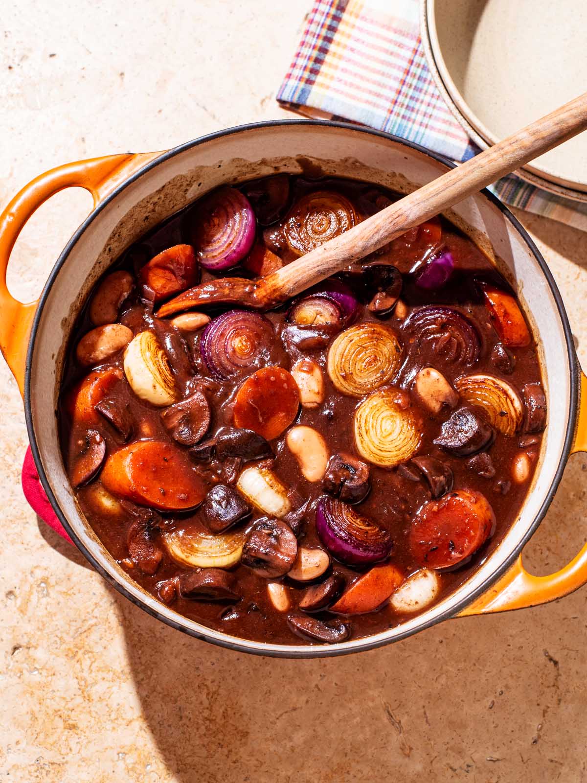 A dark mushroom stew with carrots and onions.
