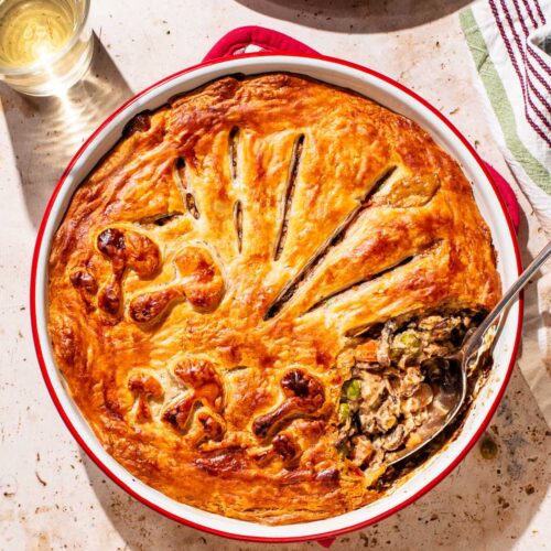 Pot pie in a baking dish with one spoonful removed.
