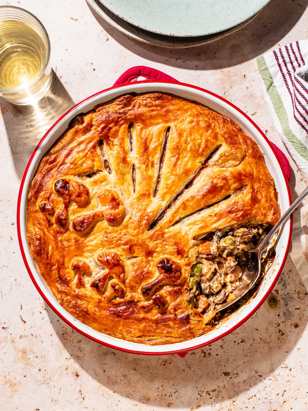 Pot pie in a baking dish with one spoonful removed.